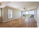 Living room featuring wood floors, large windows with plantation shutters, and a balcony at 2530 Gary Cir # 301, Dunedin, FL 34698