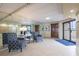 Lobby sitting area with tile floors, a mirrored wall, and comfortable blue armchairs at 2530 Gary Cir # 301, Dunedin, FL 34698