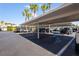 Covered parking area with multiple parking spaces available near palm trees at 2530 Gary Cir # 301, Dunedin, FL 34698