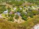 Aerial view of multiple homes with a backdrop of lush trees and swampy lands at 3041 Waterfall Dr, Spring Hill, FL 34608