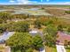 Expansive aerial view of a beautiful home surrounded by trees and overlooking marshland at 3041 Waterfall Dr, Spring Hill, FL 34608