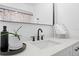 Bathroom vanity features black hardware and a well-lit mirror at 3041 Waterfall Dr, Spring Hill, FL 34608