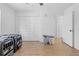 Bright bedroom features wood-look floors and closet with folding doors at 3041 Waterfall Dr, Spring Hill, FL 34608