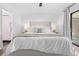 Large bedroom with ceiling fan and direct access to bathroom and outdoor patio at 3041 Waterfall Dr, Spring Hill, FL 34608
