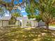 Charming home exterior featuring a gated entrance and well-manicured front yard at 3041 Waterfall Dr, Spring Hill, FL 34608