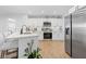 Bright kitchen with stainless steel appliances, white cabinets, and a modern quartz countertop at 3041 Waterfall Dr, Spring Hill, FL 34608