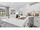 Eat-in kitchen features quartz countertops, stainless appliances, and views of the outdoor patio and pool at 3041 Waterfall Dr, Spring Hill, FL 34608