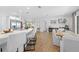 Open-concept kitchen and dining area with modern white island and stylish bar stools at 3041 Waterfall Dr, Spring Hill, FL 34608