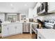 Charming eat-in kitchen with quartz countertops, stainless steel appliances, and bright decor at 3041 Waterfall Dr, Spring Hill, FL 34608