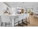 Bright, open kitchen features white cabinets, quartz countertops, and bar seating at 3041 Waterfall Dr, Spring Hill, FL 34608