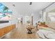 Bright living room with wood-look floors, comfortable seating, and views into the kitchen at 3041 Waterfall Dr, Spring Hill, FL 34608