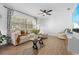 Inviting living room with a large window, cozy seating, and a ceiling fan at 3041 Waterfall Dr, Spring Hill, FL 34608