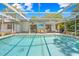 Large screened-in pool area with patio and views of the home, ideal for relaxation and outdoor entertainment at 3041 Waterfall Dr, Spring Hill, FL 34608