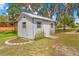 View of the white shed with gray trim in the backyard of the property at 3041 Waterfall Dr, Spring Hill, FL 34608