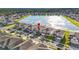 Aerial view of the neighborhood showcases lakefront properties and community layout at 3071 Marine Grass Dr, Wimauma, FL 33598