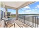 Back porch features lake views, a small table set, and relaxing seating, perfect for outdoor living at 3071 Marine Grass Dr, Wimauma, FL 33598