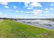 Expansive backyard overlooking a serene lake, creating a peaceful outdoor space at 3071 Marine Grass Dr, Wimauma, FL 33598