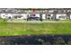 The backyard view captures the home's proximity to the water with a serene pond right behind the property at 3071 Marine Grass Dr, Wimauma, FL 33598