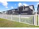 A fenced backyard with a screened-in porch area, with lush grass and privacy at 3071 Marine Grass Dr, Wimauma, FL 33598