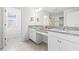 Bright bathroom with granite counters, dual sinks, vanity, and tiled floors at 3071 Marine Grass Dr, Wimauma, FL 33598