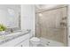 Modern bathroom featuring a glass shower, granite countertop and white cabinets at 3071 Marine Grass Dr, Wimauma, FL 33598