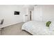 Bright bedroom with neutral decor and a view into the hallway at 3071 Marine Grass Dr, Wimauma, FL 33598