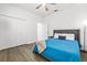 Bright bedroom with hardwood floor, ceiling fan, and a closet at 3071 Marine Grass Dr, Wimauma, FL 33598
