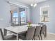 Elegant dining area with a large window, stylish table and seating for six at 3071 Marine Grass Dr, Wimauma, FL 33598