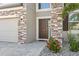 Close up of front door and stone facade, featuring a 