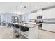 Modern kitchen with a large island, granite countertops, and stainless steel appliances at 3071 Marine Grass Dr, Wimauma, FL 33598