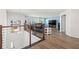 Open-concept living room showcasing modern design, hardwood floors, and bright lighting at 3071 Marine Grass Dr, Wimauma, FL 33598