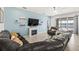 Comfortable living room boasts a cozy fireplace, mounted TV, and sliding doors to the outdoor space at 3071 Marine Grass Dr, Wimauma, FL 33598