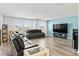 Inviting living room with ample natural light, hardwood flooring and modern furnishings at 3071 Marine Grass Dr, Wimauma, FL 33598