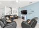 Open living room features modern ceiling fan, fireplace, a TV, and staircase access to upper floors at 3071 Marine Grass Dr, Wimauma, FL 33598