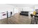 Spacious living room with hardwood flooring, comfortable seating, and plenty of natural light at 3071 Marine Grass Dr, Wimauma, FL 33598