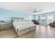 Spacious main bedroom features a walk-in closet, a comfortable massage chair, and backyard views at 3071 Marine Grass Dr, Wimauma, FL 33598