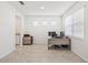 Bright home office with natural light, tiled flooring, and ample workspace at 3071 Marine Grass Dr, Wimauma, FL 33598