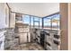 Elegant outdoor kitchen featuring stone accents, stainless steel appliances, and a granite countertop bar at 3071 Marine Grass Dr, Wimauma, FL 33598
