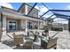 Spacious outdoor patio with comfortable seating and a screened enclosure at 3071 Marine Grass Dr, Wimauma, FL 33598