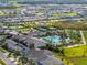 Expansive aerial view showcases the resort-style amenities, pool, tennis courts, and neighborhood layout at 31510 Cabana Rye Ave, San Antonio, FL 33576