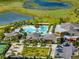 Elevated view showing the impressive pool, tennis courts, modern clubhouse, and lush landscaping at 31510 Cabana Rye Ave, San Antonio, FL 33576