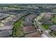 An aerial view showcases a well-maintained home with a large backyard, complemented by the neighborhood's lush landscaping at 31510 Cabana Rye Ave, San Antonio, FL 33576