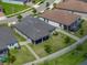 Aerial shot displays a spacious backyard with a covered patio, surrounded by a white fence and lush green lawn at 31510 Cabana Rye Ave, San Antonio, FL 33576