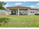 Expansive backyard with a covered patio and ample seating, perfect for outdoor gatherings at 31510 Cabana Rye Ave, San Antonio, FL 33576