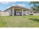Lush backyard featuring a covered patio and serene views at 31510 Cabana Rye Ave, San Antonio, FL 33576