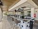 Outdoor bar with plenty of seating, large screen televisions, and stone detailing at 31510 Cabana Rye Ave, San Antonio, FL 33576