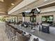Outdoor bar area with seating, TV screens, and a well-equipped counter for serving beverages at 31510 Cabana Rye Ave, San Antonio, FL 33576