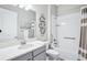 Bright bathroom featuring a shower-tub combination, white vanity with gray cabinets, and accessible handrails at 31510 Cabana Rye Ave, San Antonio, FL 33576