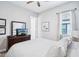 A cozy bedroom features neutral tones, wood-look floors, a ceiling fan, and a queen bed with patterned bedding at 31510 Cabana Rye Ave, San Antonio, FL 33576