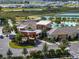 Panoramic view of the clubhouse highlighting the community pool, lakeside setting, and overall elegance at 31510 Cabana Rye Ave, San Antonio, FL 33576